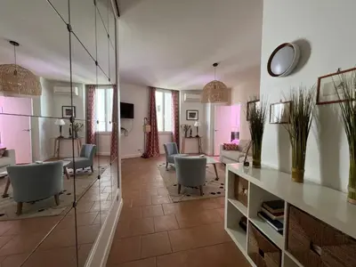 a living room with chairs and a table at Viva Riviera - 10 Rue Florian in Cannes