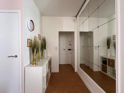 a bathroom with white walls and a large mirror at Viva Riviera - 10 Rue Florian in Cannes