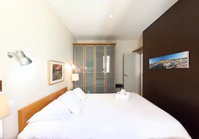 a bedroom with a large white bed in a room at Viva Riviera - 10 Rue Florian in Cannes