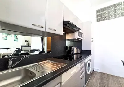 a kitchen with a sink and a counter top at Viva Riviera - 10 Rue Florian in Cannes