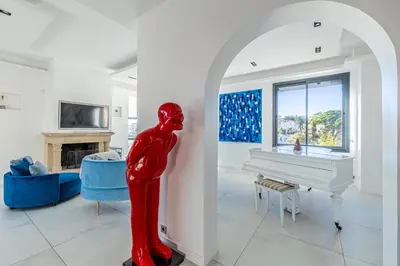 a red statue in a living room with a white piano at New! Villa de luxe centre Cannes in Cannes