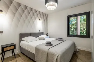 a bedroom with a large bed in a room at New! Villa de luxe centre Cannes in Cannes