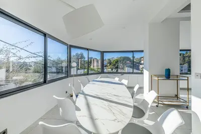 a white dining room with a table and white chairs at New! Villa de luxe centre Cannes in Cannes