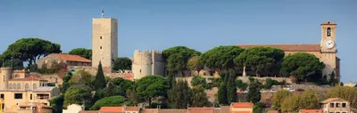 a city with two towers and a clock tower at le suquet entre palais et des plages in Cannes