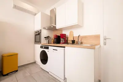 a kitchen with a washer and dryer in it at le suquet entre palais et des plages in Cannes