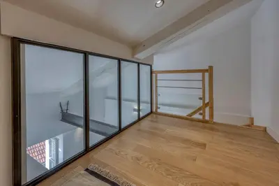 an empty room with glass walls and a wooden floor at Loft Croisette Standing Presta in Cannes