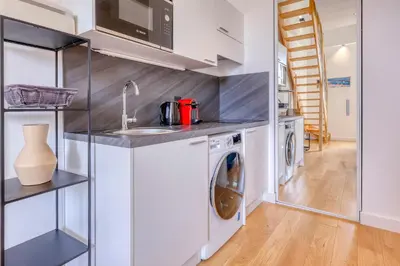 a kitchen with a sink and a washing machine at Loft Croisette Standing Presta in Cannes