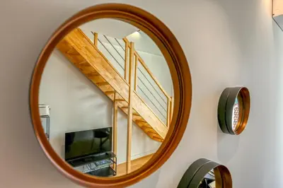a mirror with a staircase in a living room at Loft Croisette Standing Presta in Cannes