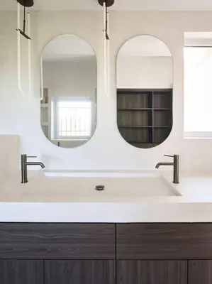 a bathroom with a white sink and two mirrors at Cannes, splendide villa dans un domaine privé in Le Cannet