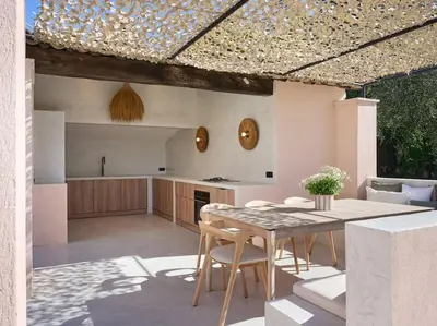 a kitchen and dining area with a table and chairs at Cannes, splendide villa dans un domaine privé in Le Cannet