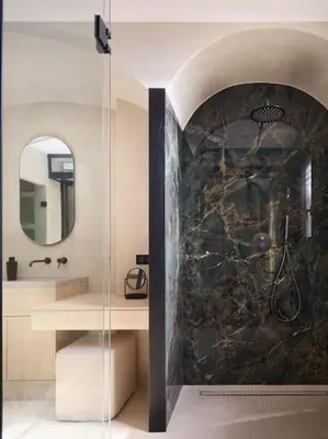 a bathroom with a shower with a stone wall at Cannes, splendide villa dans un domaine privé in Le Cannet