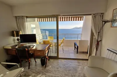a living room with a desk and a view of the ocean at Cannes SEASIDE BEACHFRONT bord de mer in Cannes