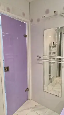 a bathroom with a purple door and a mirror at Cannes SEASIDE BEACHFRONT bord de mer in Cannes