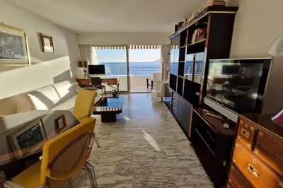 a living room with a television and a living room with the ocean at Cannes SEASIDE BEACHFRONT bord de mer in Cannes