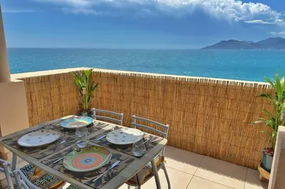a table and chairs with a view of the ocean at Le Seaview-Quiet-Swimming pool-Car park-Seafront in Cannes