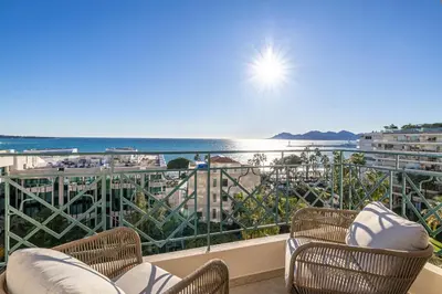a balcony with chairs and a view of the ocean at 1974 - Luxurious 3 bedrooms - Sea view & Parking in Cannes