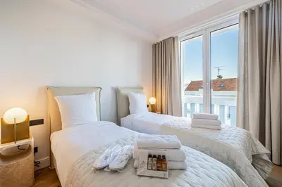 a bedroom with two beds and a large window at 1974 - Luxurious 3 bedrooms - Sea view & Parking in Cannes