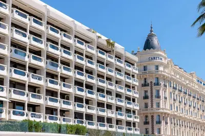 an office building with a tower in the background at 1973 - Luxurious waterfront apartment Croisette in Cannes