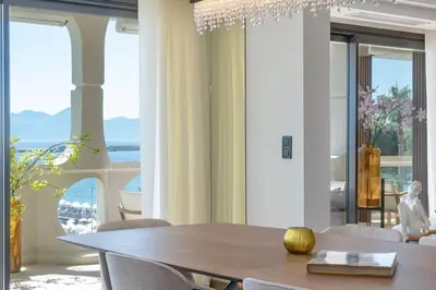 a dining room with a table and views of the ocean at 1973 - Luxurious waterfront apartment Croisette in Cannes