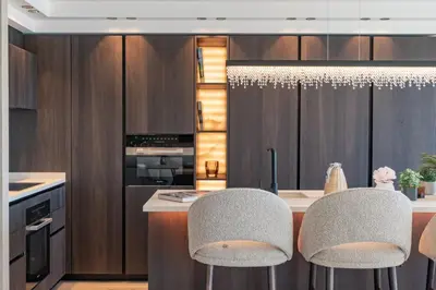 a kitchen with a counter with two chairs and a island at 1973 - Luxurious waterfront apartment Croisette in Cannes