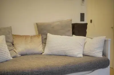 a bunch of pillows sitting on a couch at Le Nico - Elégant - Centre - VCA in Cannes