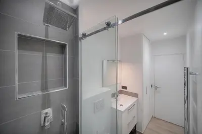 a bathroom with a glass shower and a sink at Le Nico - Elégant - Centre - VCA in Cannes