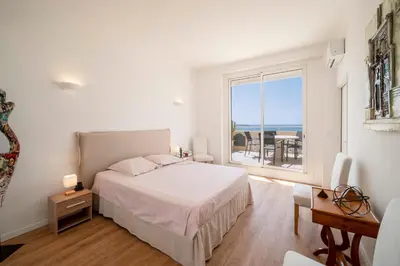 a bedroom with a bed and a view of the ocean at Cannes - Roof terrace for rent in Cannes