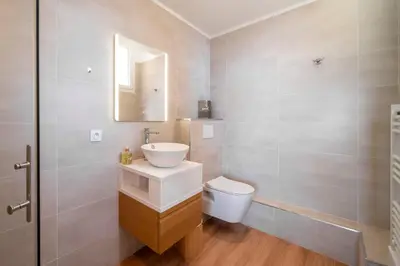 a bathroom with a sink and a toilet and a mirror at Cannes - Roof terrace for rent in Cannes