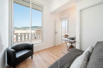 a bedroom with a bed and a desk and a window at Cannes - Roof terrace for rent in Cannes