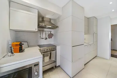a kitchen with white cabinets and a stove at REF 1319 - Cannes Center - Apartment for rent in Cannes