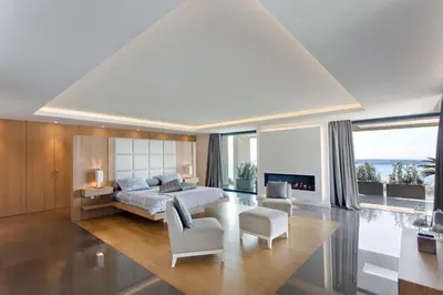 a bedroom with a king sized bed and a living room at REF 1960 - Cannes - Sea view villa for rent in Cannes