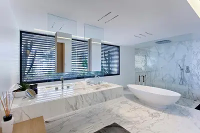 a bathroom with a tub and a sink and a mirror at REF 1960 - Cannes - Sea view villa for rent in Cannes