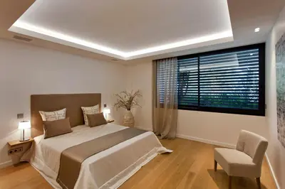 a bedroom with a large bed and a large window at REF 1960 - Cannes - Sea view villa for rent in Cannes