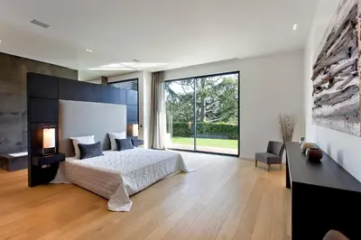 a bedroom with a large bed and a large window at REF 1960 - Cannes - Sea view villa for rent in Cannes