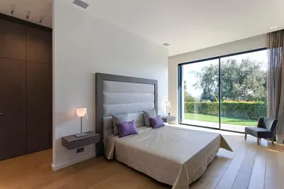 a bedroom with a large bed and a large window at REF 1960 - Cannes - Sea view villa for rent in Cannes