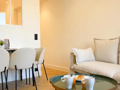 a living room with a couch and a table at 9A - APARTMENT FACING PORT & Town Hall in Cannes