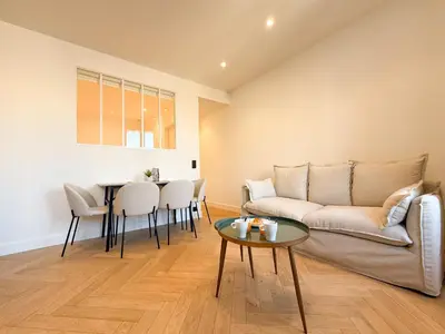 a living room with a couch and a table at 9A - APARTMENT FACING PORT & Town Hall in Cannes