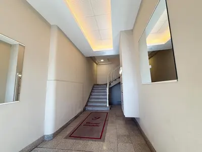 a hallway with stairs and a red rug on the floor at 9A - APARTMENT FACING PORT & Town Hall in Cannes