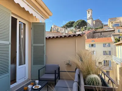 a balcony with a table and a chair on a balcony at 9A - APARTMENT FACING PORT & Town Hall in Cannes