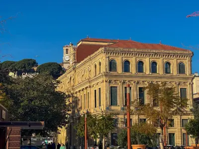 a large building with a clock tower on top of it at 12B - APARTMENT FACING PORT & Town Hall in Cannes