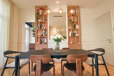 a dining room with a black table and chairs at 12B - APARTMENT FACING PORT & Town Hall in Cannes