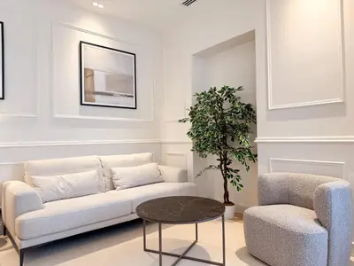 a living room with a couch and a chair at 12B - APARTMENT FACING PORT & Town Hall in Cannes