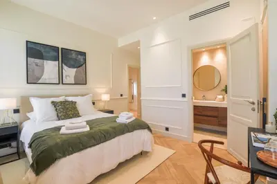 a bedroom with a large bed and a bathroom at 12B - APARTMENT FACING PORT & Town Hall in Cannes