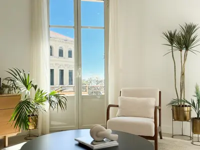 a living room with a chair and a table at 4A - APARTMENT FACING PORT & Town Hall in Cannes