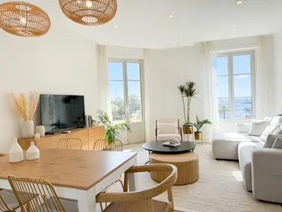 a living room with a couch and a table at 4A - APARTMENT FACING PORT & Town Hall in Cannes