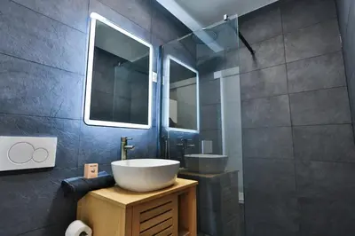 a bathroom with a sink and a mirror at Spacieux T2 avec grande terrasse à 200m de la plage in Cannes