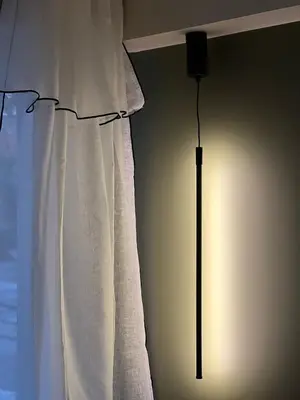 a lamp in a room next to a curtain at Palm Beach front de mer in Cannes