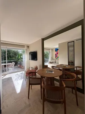 a dining room with tables and chairs and a patio at Palm Beach front de mer in Cannes