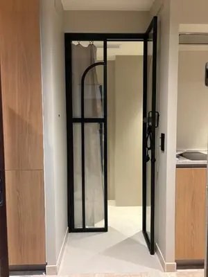 a sliding glass door in a room with a kitchen at Palm Beach front de mer in Cannes
