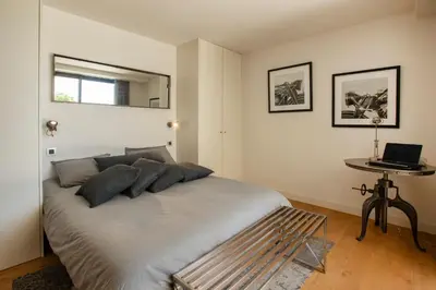 a bedroom with a bed and a table with a laptop at REF 2152 - Le Cannet - Sea view villa for rent in Le Cannet